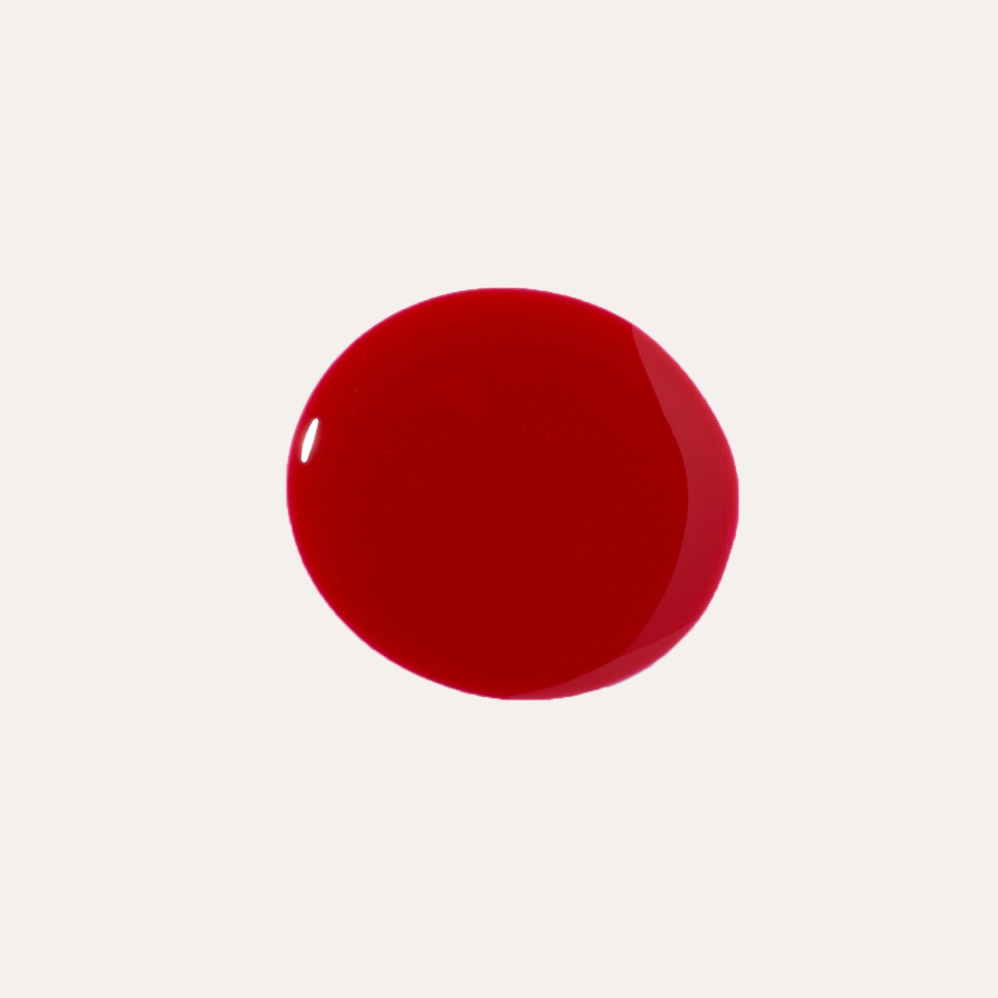 Luxe Lip Nourishing Oil shown as a glossy, rich red swatch with a smooth, rounded shape.