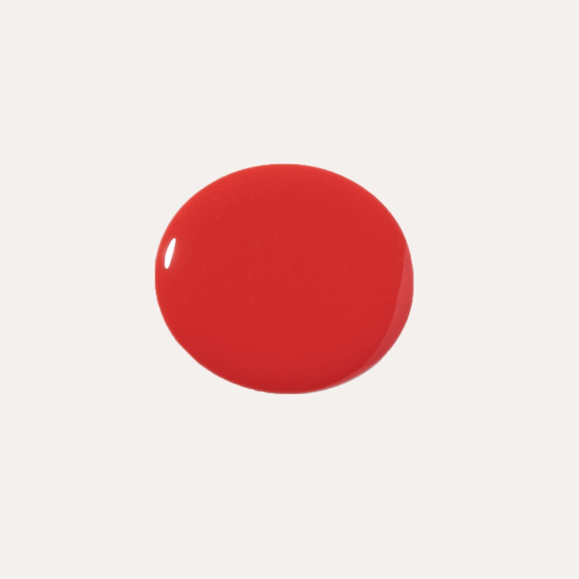 Luxe Lip Nourishing Oil in a vibrant red shade with a smooth, glossy finish and rounded swatch shape