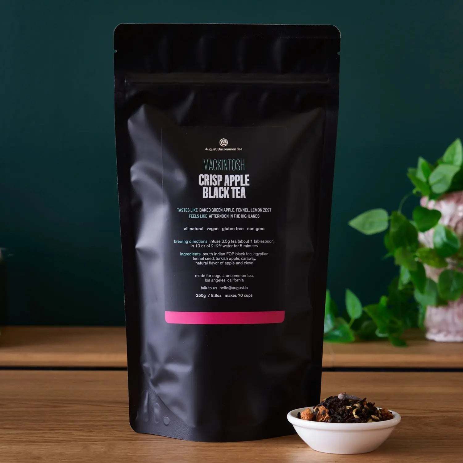 Mackintosh - Crisp Apple Black Tea in a matte black resealable pouch with pink label and loose tea bowl