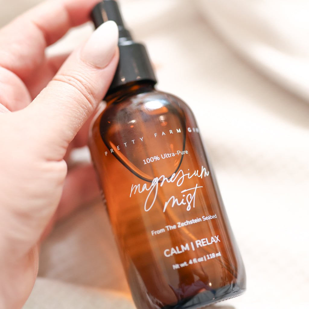 Magnesium Mist Body Spray in an amber glass bottle with black spray top and white lettering

