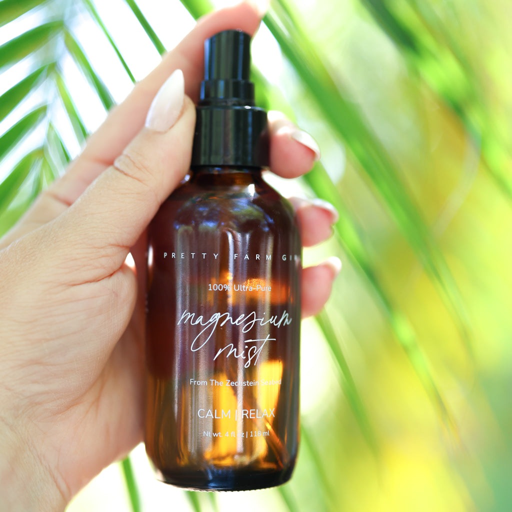 Magnesium Mist Body Spray in an amber glass bottle with black spray top and white script label