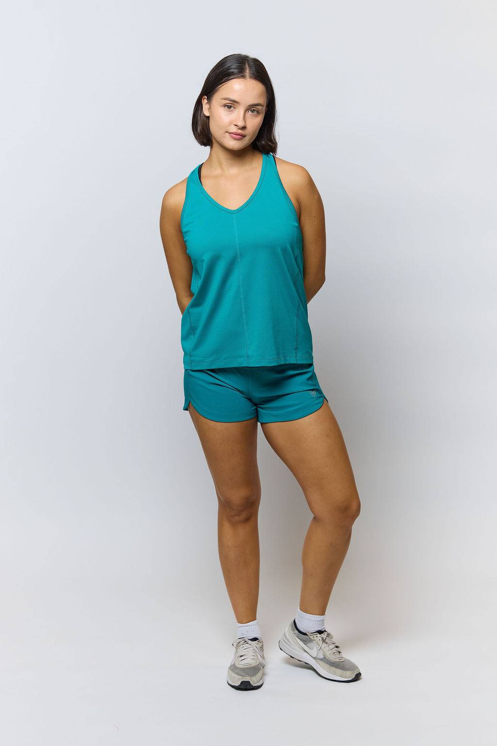 Mesh It To Me Tank in solid teal mesh with a sleeveless cut, V-neckline, roomy fit and shaped hem