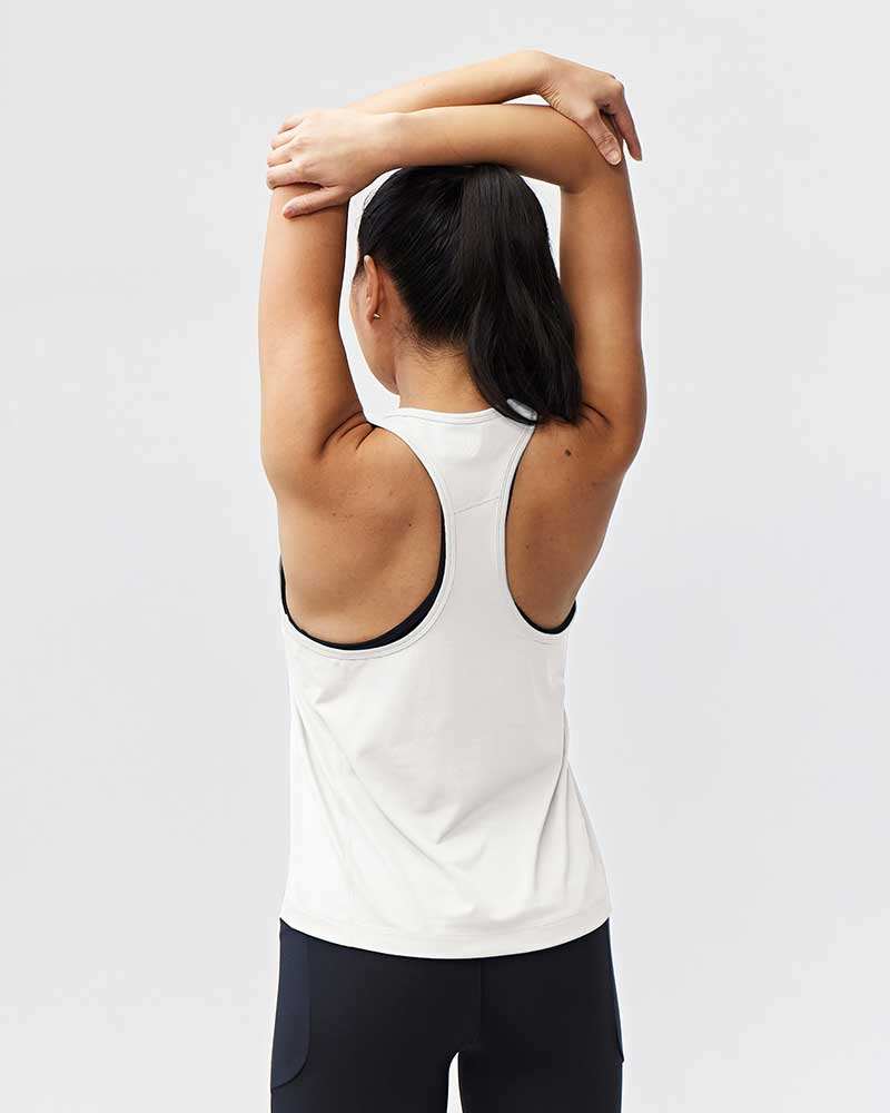 Mesh It To Me Tank in white with a racerback cut, black trim, and a relaxed sleeveless fit