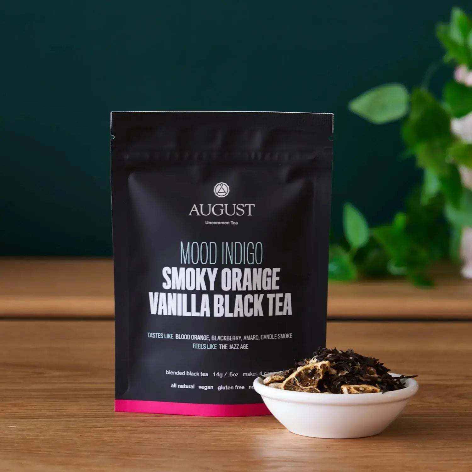 Mood Indigo - BLACK TEA in a black pouch, featuring smoky orange vanilla blend and loose tea leaves in a bowl