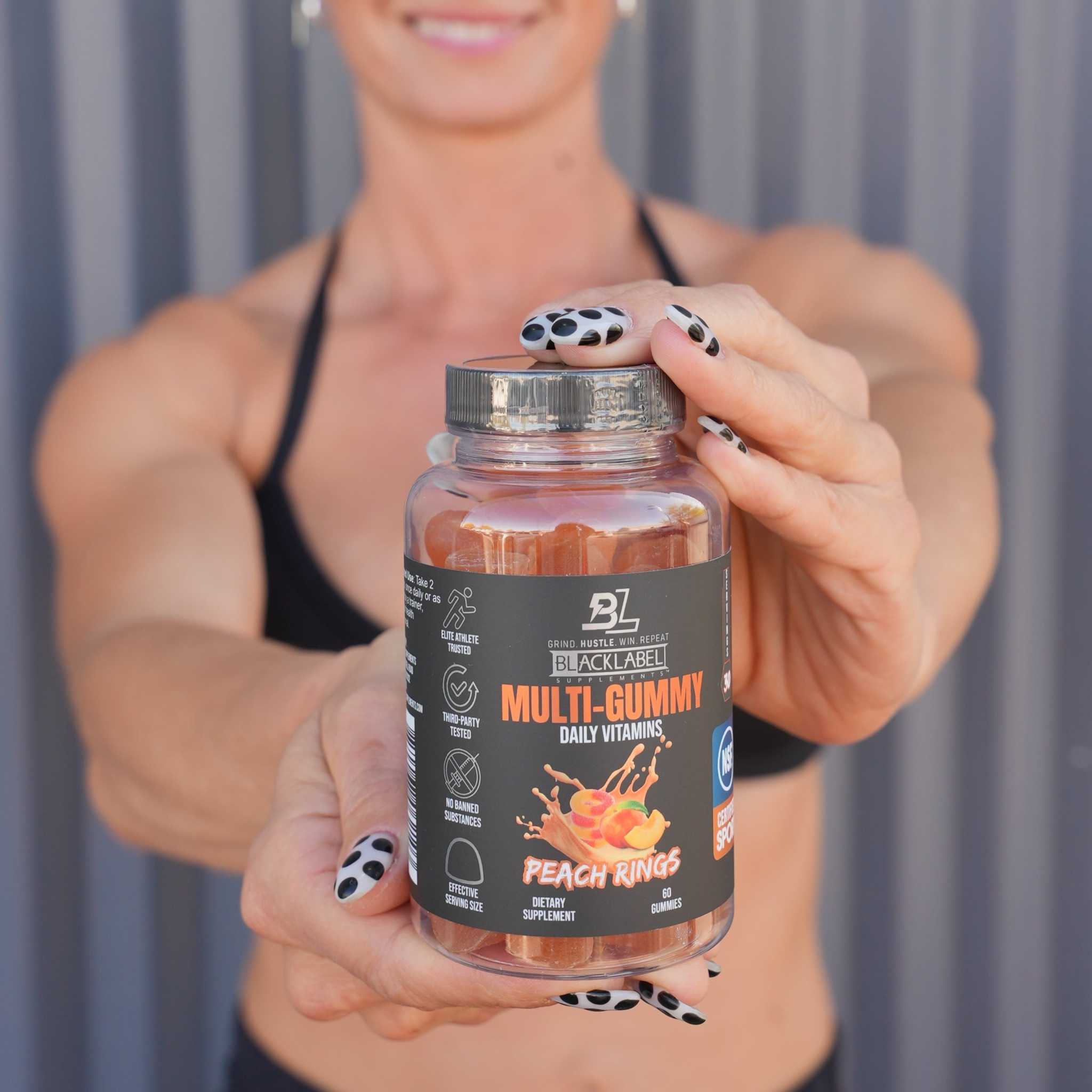 MULTI GUMMY peach rings vitamin supplement in a clear bottle with a black label and orange lettering