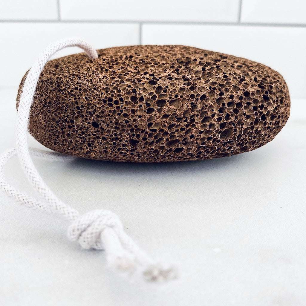 Natural Volcanic Lava Stone exfoliating pumice in mottled dark brown porous basalt with a white hanging cord