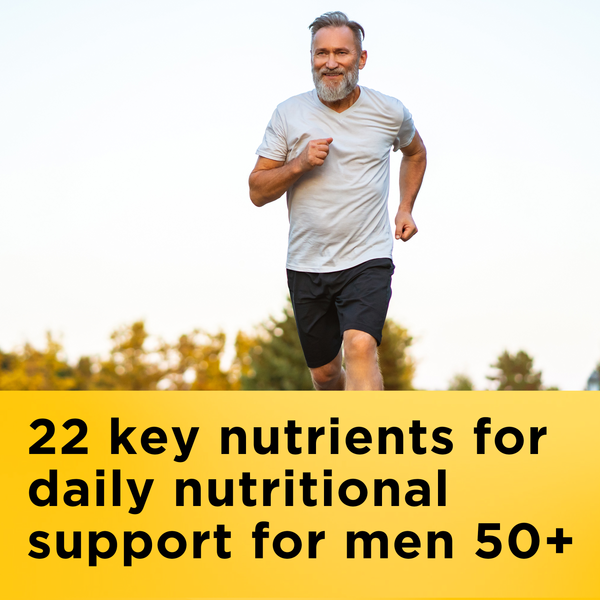 Fitness-focused bearded man in white t-shirt and black shorts running outdoors representing Nature Made Multivitamin men 50+ daily support.