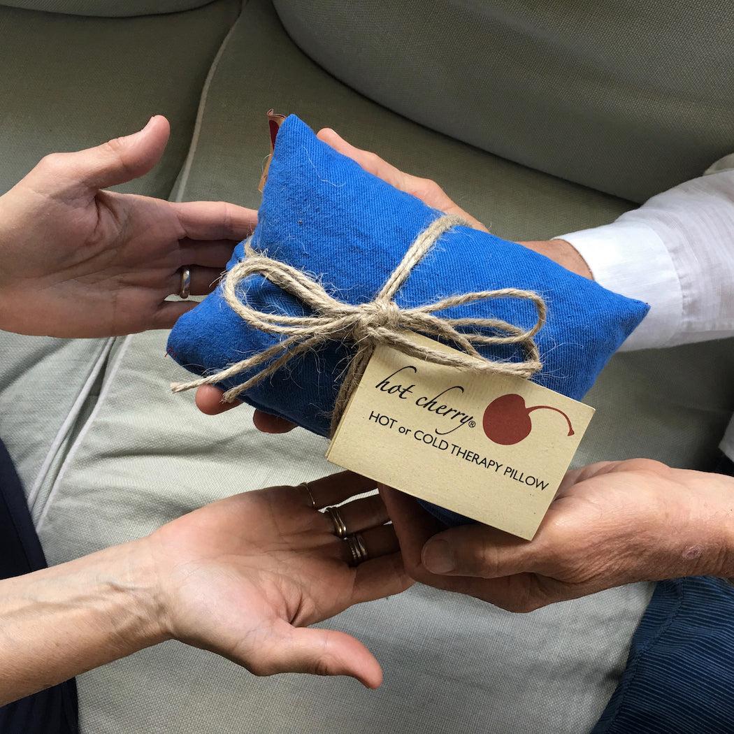 Neck Wrap in Blue Denim made from bright blue textured cotton, folded into a pillow and tied with natural twine.