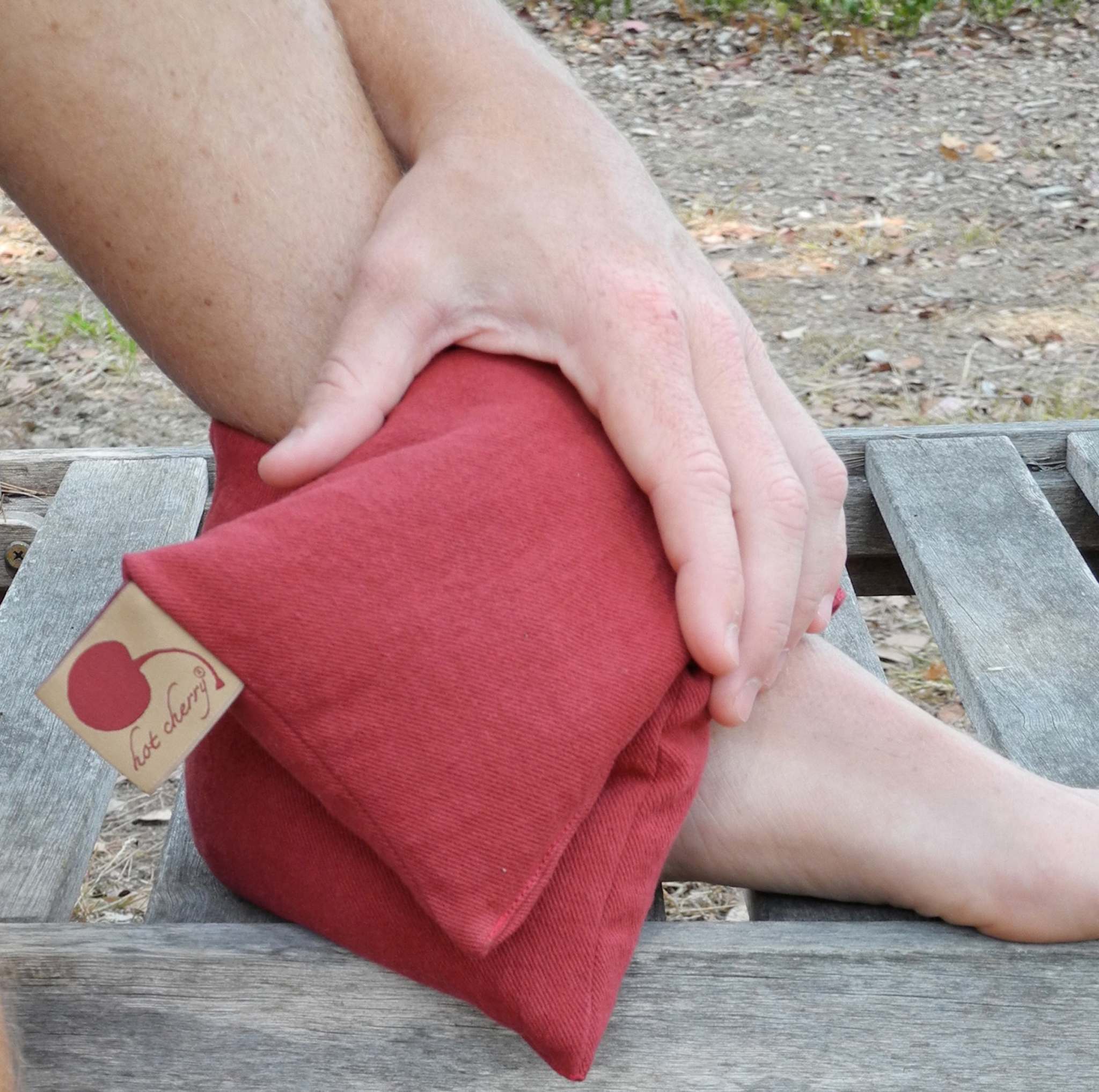 Neck Wrap in red cotton denim with a soft, solid-color fabric and a small cherry-branded tag