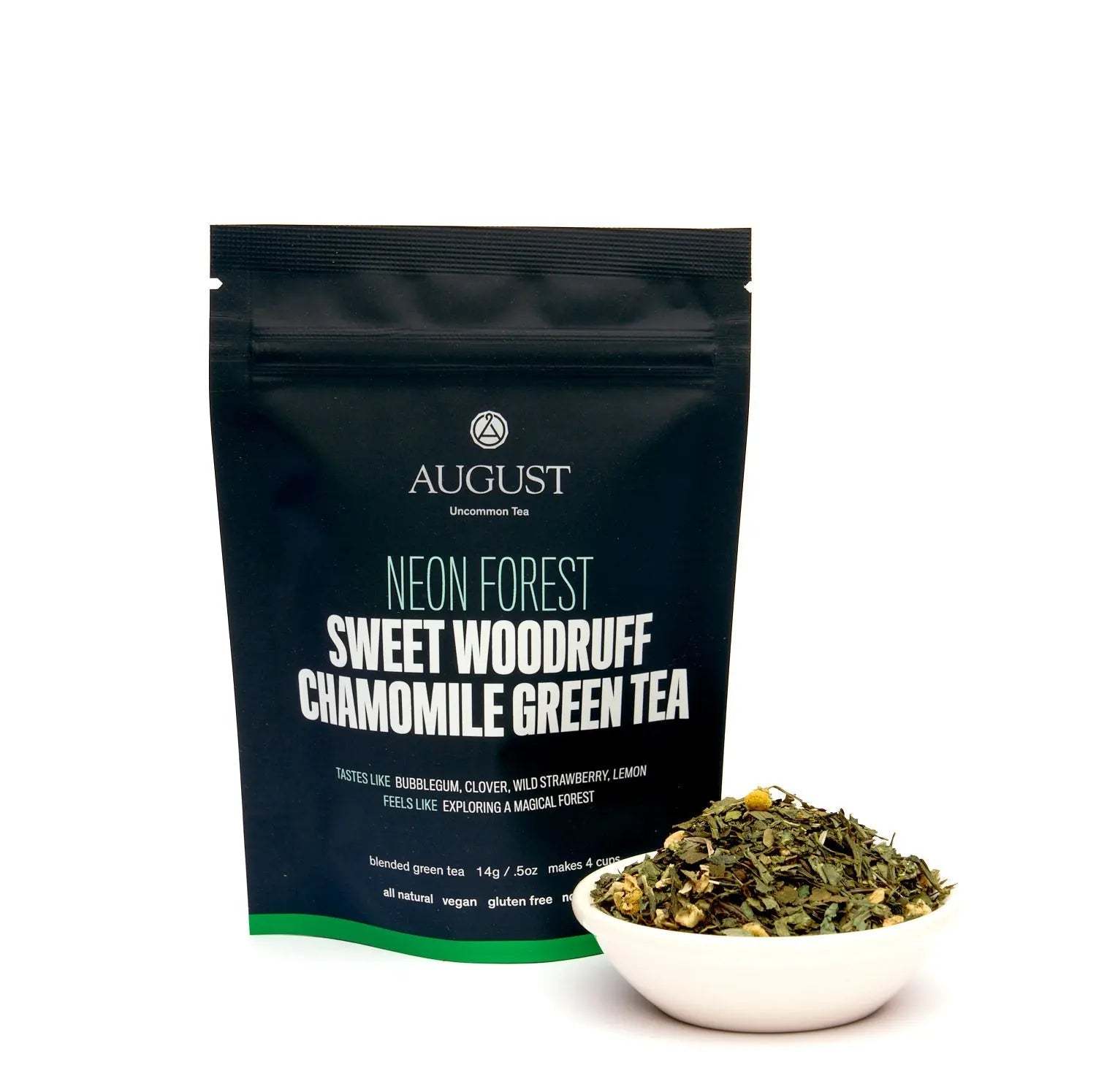 Neon Forest green tea in a black resealable pouch beside a bowl of loose leafy tea with flower pieces