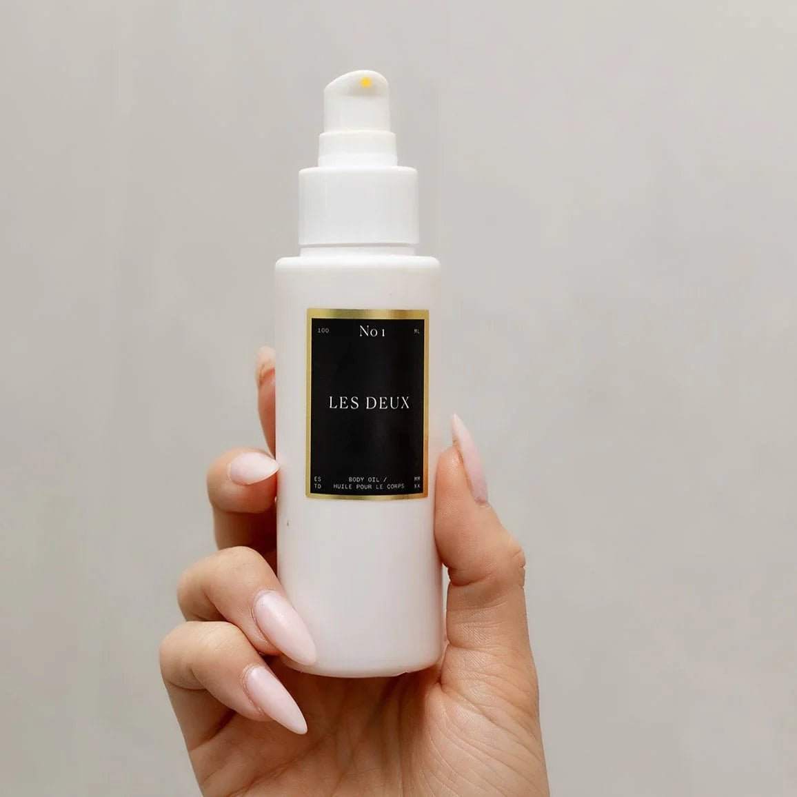 No. 1 - Bois Sacré Body Oil in a white pump bottle with a black and gold label, 100 ml