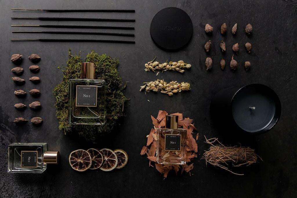 No. 1 - Bois Sacré Candle, matte black container with matching lid and lit wick, designed for a smoky woody scent