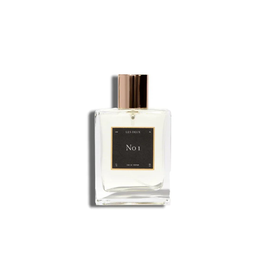 No. 1 - Bois Sacré Perfume in a clear glass bottle with a black label and metallic bronze cap