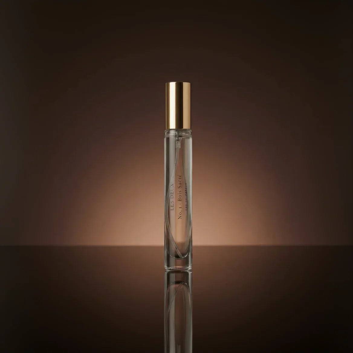No. 1 - Bois Sacré Perfume in a slim clear glass vial with a metallic gold cap and printed label