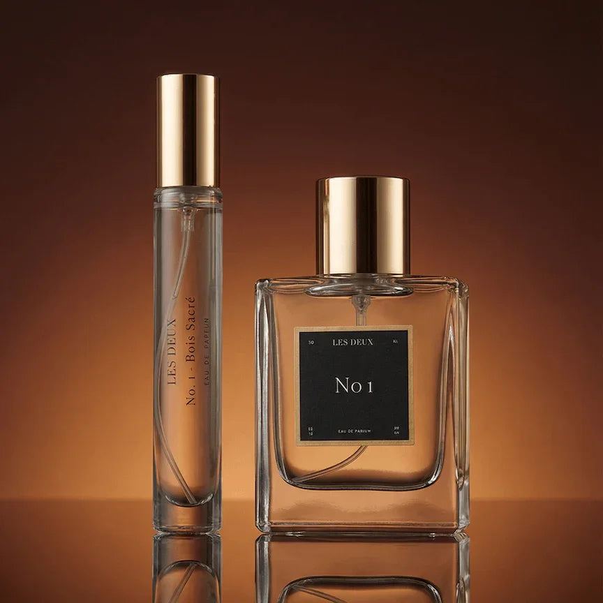 No. 1 - Bois Sacré Perfume in clear glass bottles with amber fragrance and polished gold caps
