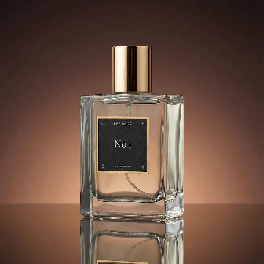 No. 1 - Bois Sacré Perfume in a clear glass bottle with a gold cap and black label detailing
