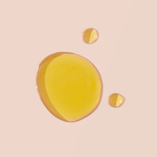 No. 2 - Peau d’Or Body Oil, golden yellow oil droplets with a glossy, translucent finish