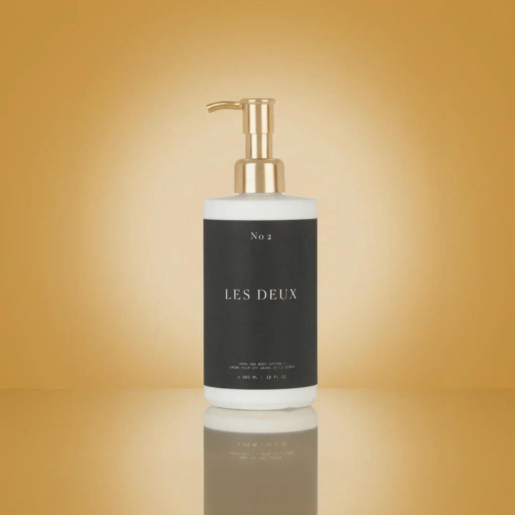No. 2 - Peau d’Or Body Lotion in a black rectangular bottle with a white base and gold pump dispenser