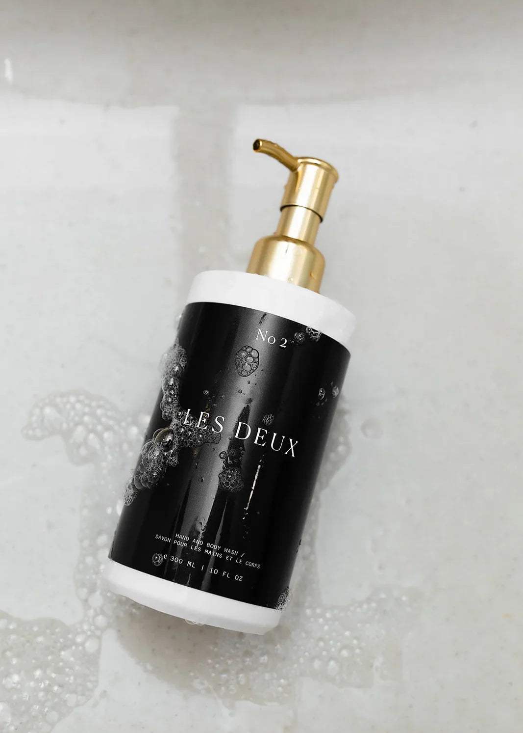 No. 2 - Peau d’Or Body Wash in a black bottle with white accents, gold pump, and bubble-patterned label