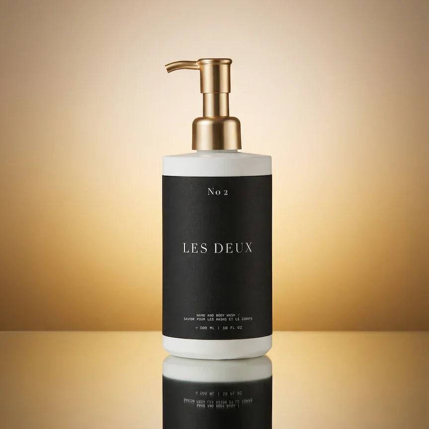 No. 2 - Peau d’Or Body Wash in a black and white bottle with a metallic gold pump dispenser