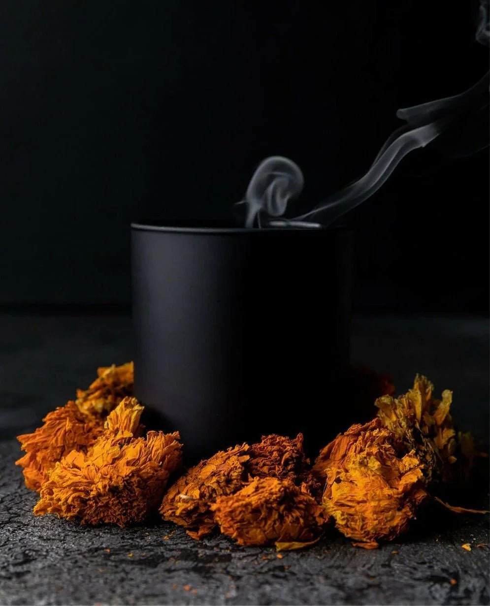 No. 2 - Peau d’Or Candle in a matte black metal container with dried orange marigold flowers