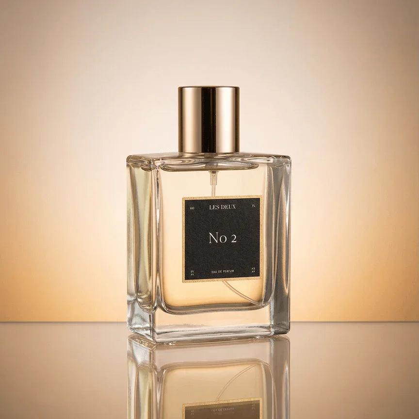 No. 2 - Peau d’Or Perfume in a clear glass bottle with golden amber liquid and metallic gold cap