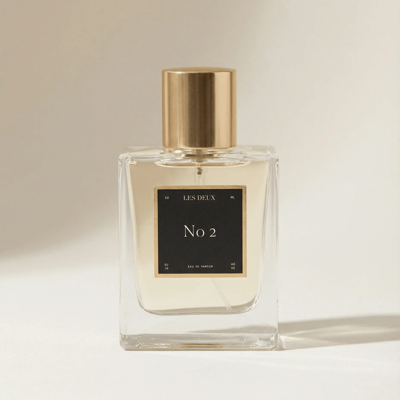 No. 2 - Peau d’Or Perfume in a clear glass bottle with a gold cap and black square label