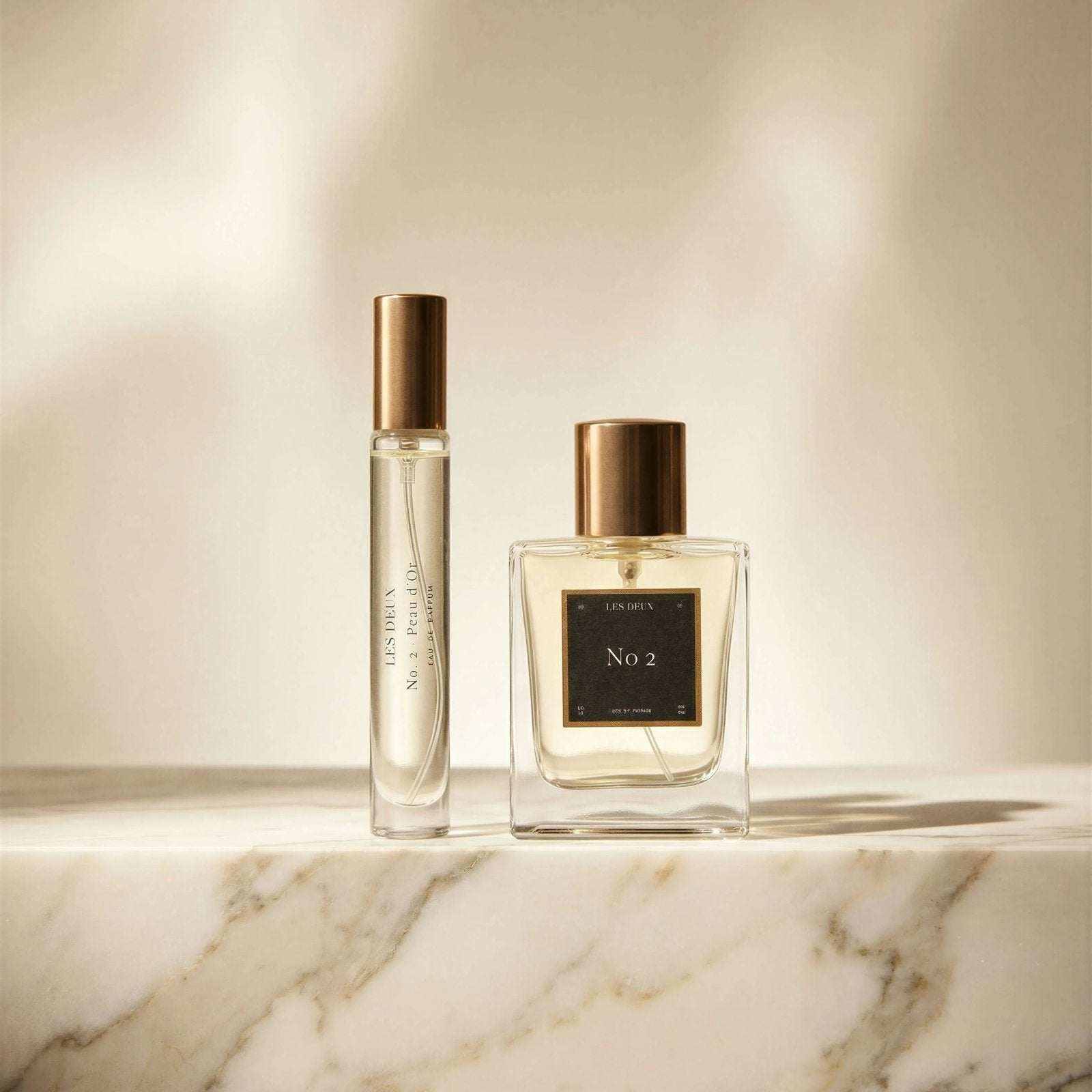 No. 2 - Peau d’Or Perfume in clear glass bottles with gold caps and pale amber fragrance