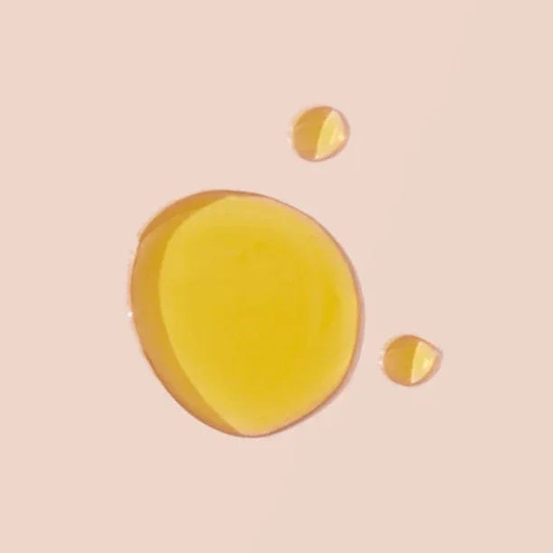 No. 3 - Brume Ardente Body Oil shown as a glossy golden yellow oil droplet with smaller droplets