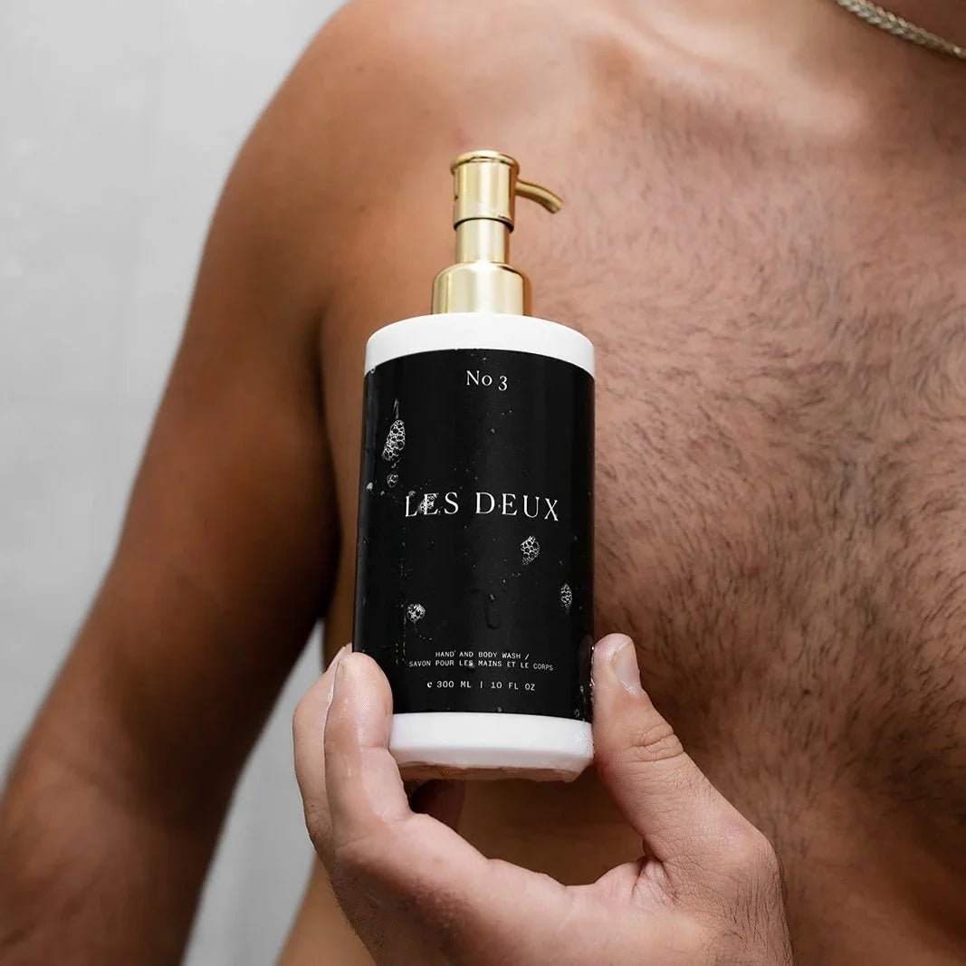 No. 3 - Brume Ardente Body Wash in a black and white bottle with a gold pump dispenser