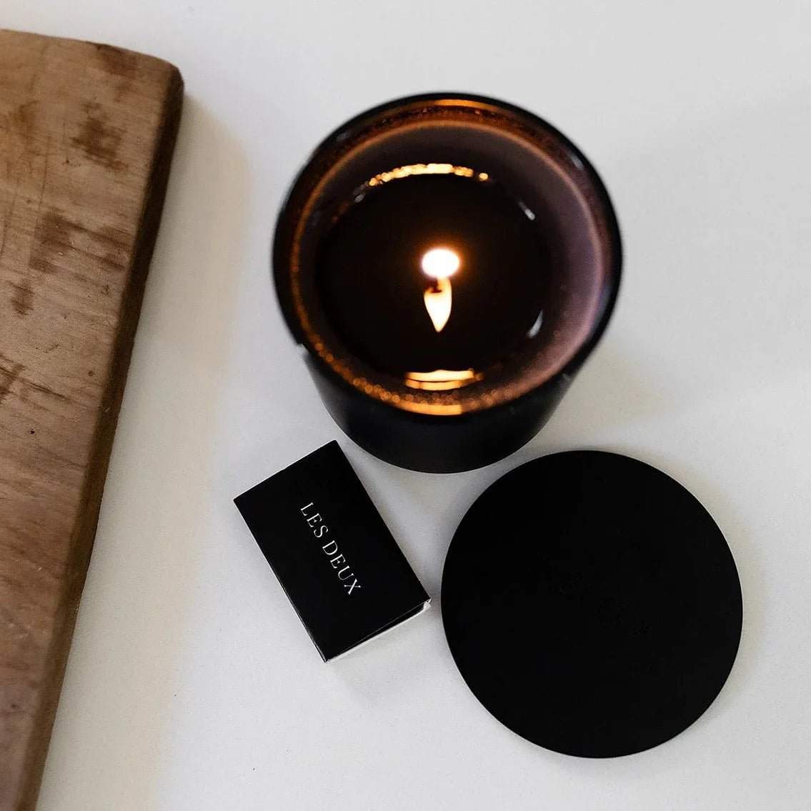 No. 3 - Brume Ardente Candle in a dark amber glass vessel with a lit wick, black lid and matches