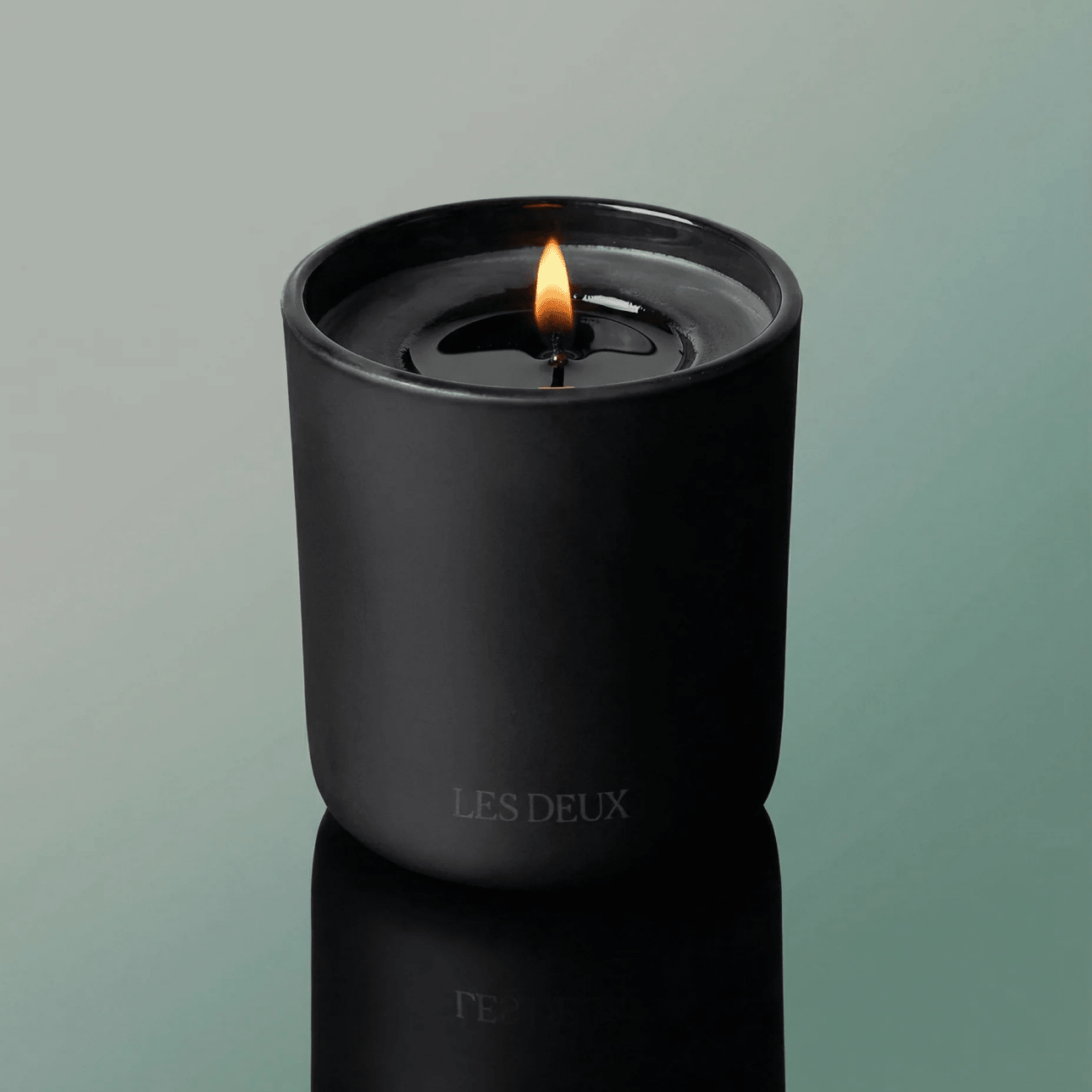No. 3 - Brume Ardente Candle in a sleek matte black container with a lit wick and smooth finish