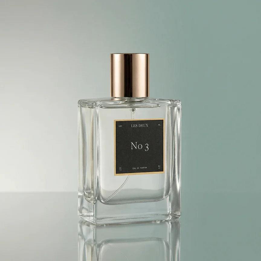 No. 3 - Brume Ardente Perfume in a clear glass bottle with a metallic rose-gold cap and black label