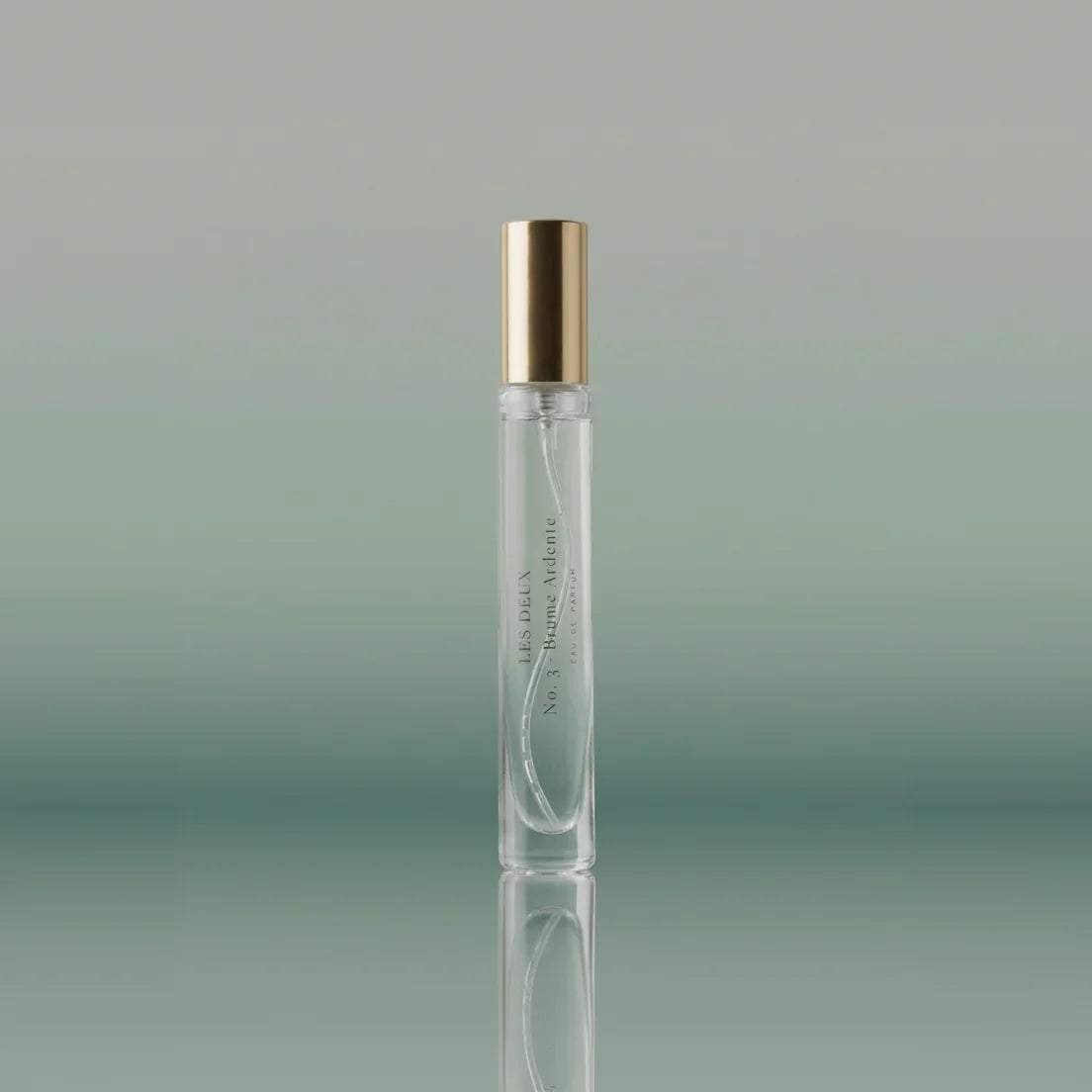 No. 3 - Brume Ardente Perfume in a clear glass travel vial with a polished gold cap and minimalist label