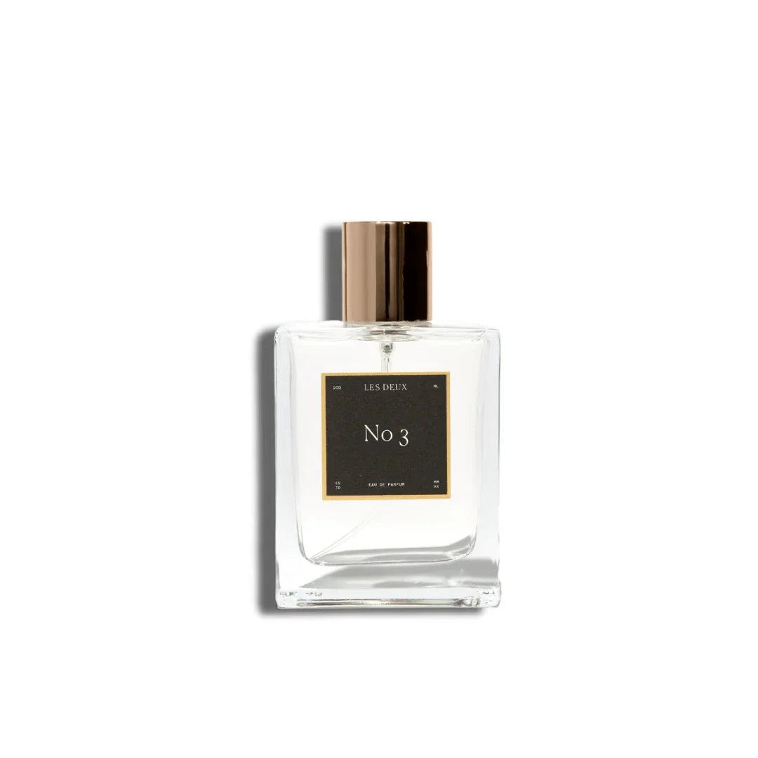 No. 3 - Brume Ardente Perfume in a clear glass bottle with a black label and gold cylindrical cap