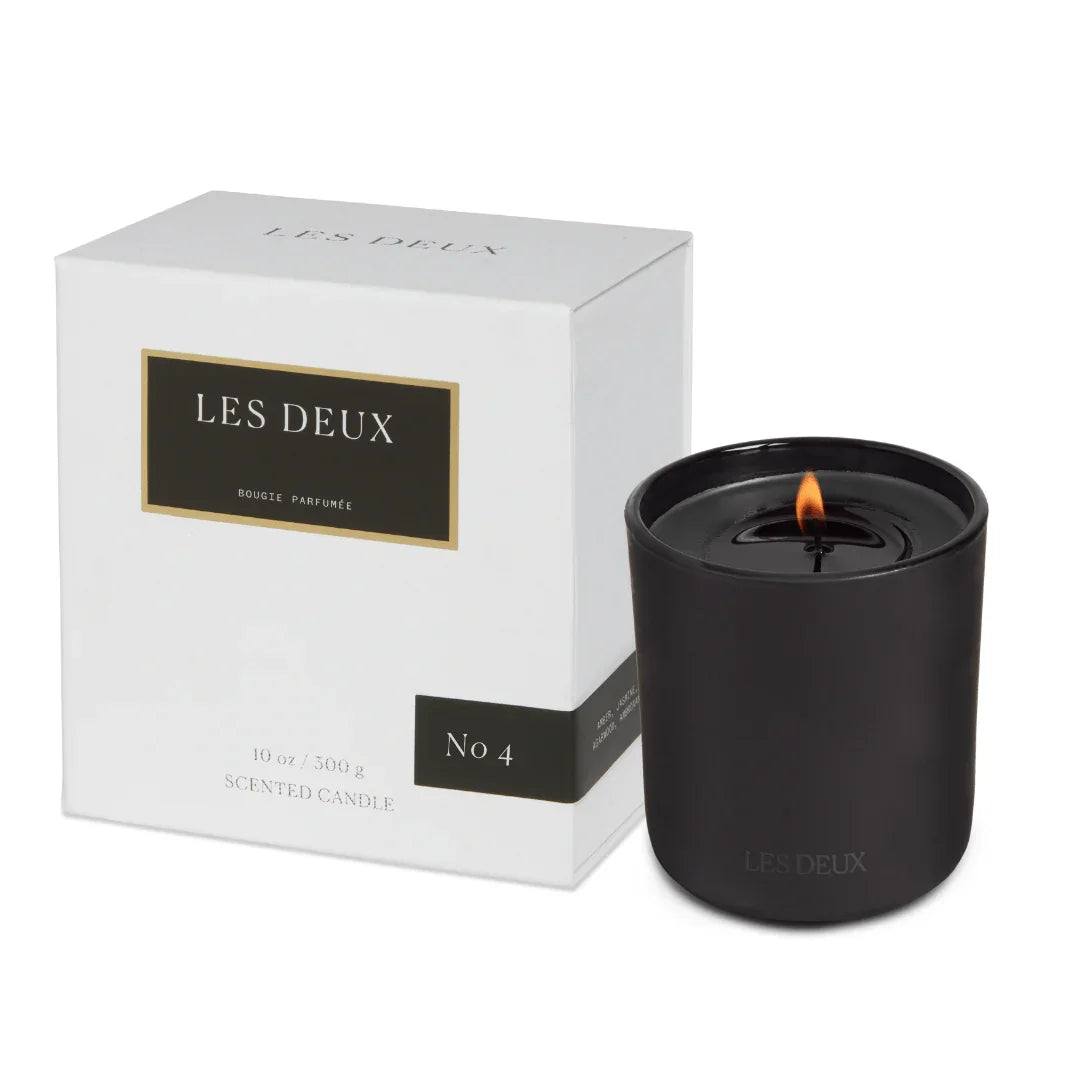 No. 4 - L'Âme Velours Candle in a matte black vessel, with a lit wick and white presentation box