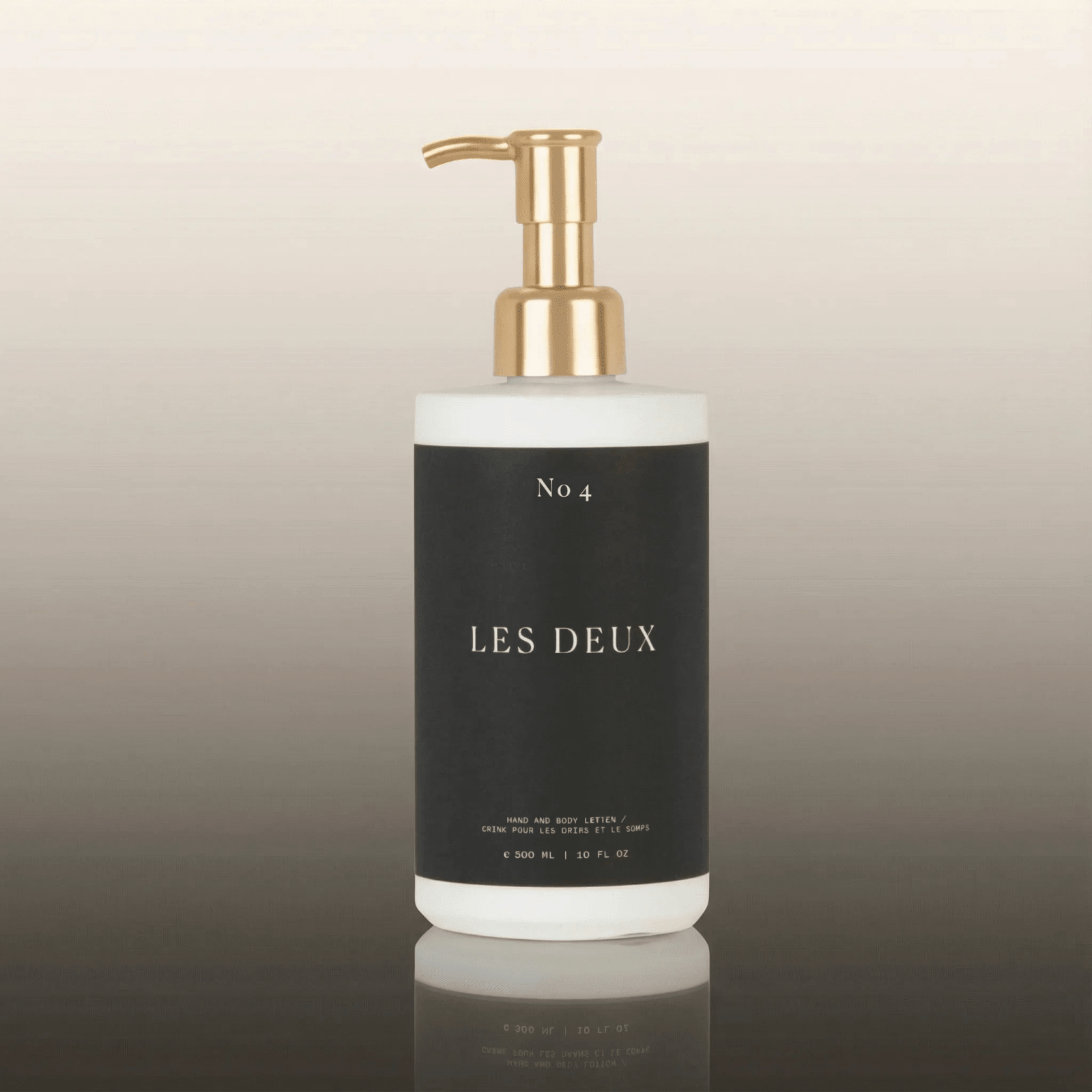 No. 4 - L'Âme Velours Body Lotion in a black and white bottle with a gold pump dispenser