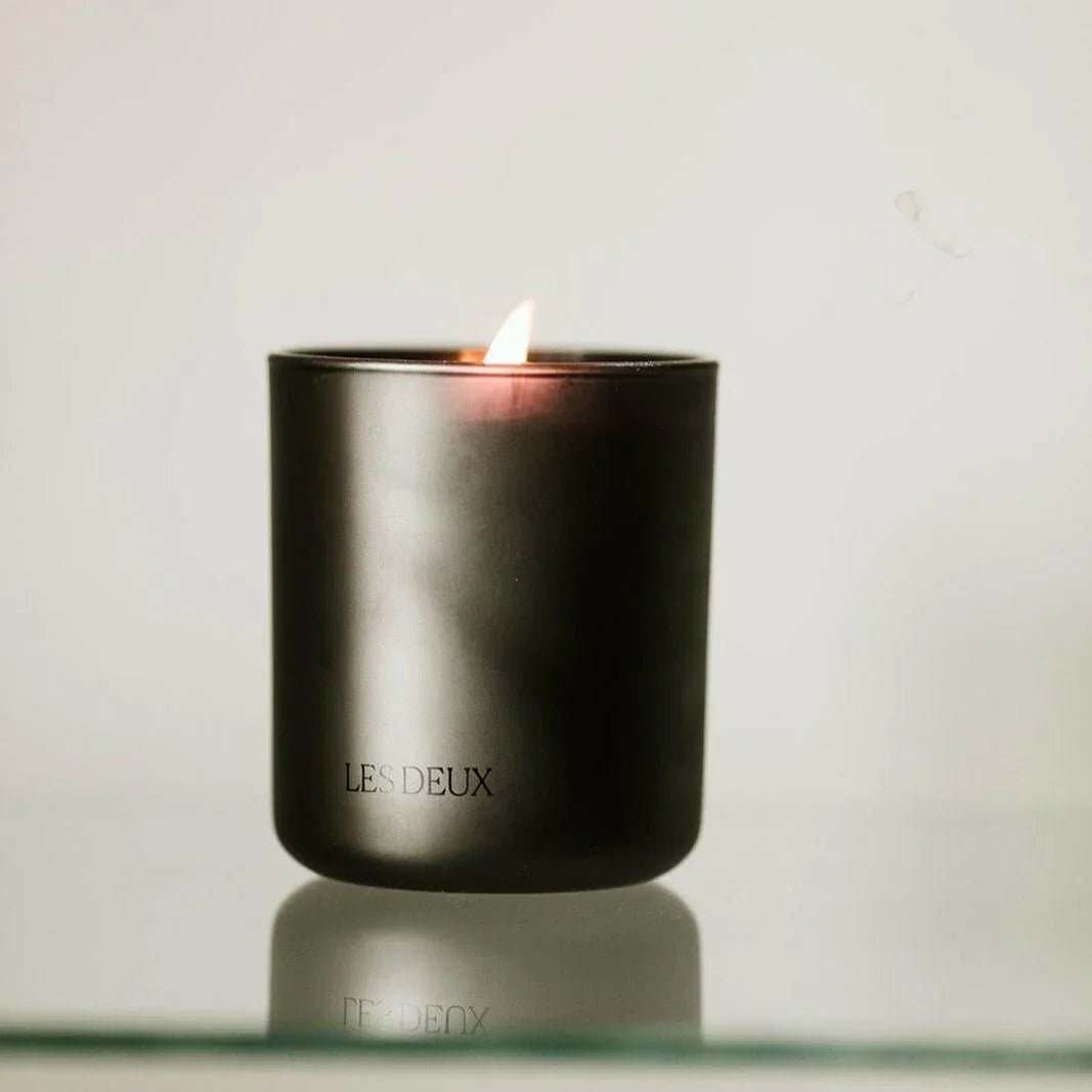 No. 4 - L'Âme Velours Candle in a sleek matte black container, featuring a warm burning flame and subtle branding