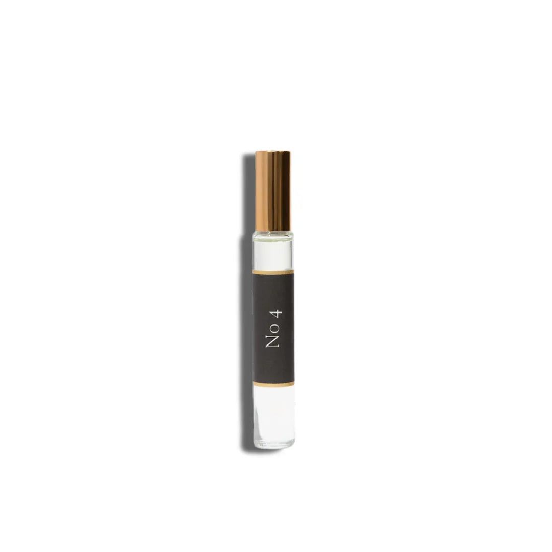 Roll-on perfume oil in a slim clear glass vial with a dark label, gold cap, and No. 4 - L'Âme Velours Roll On Perfume Oil text