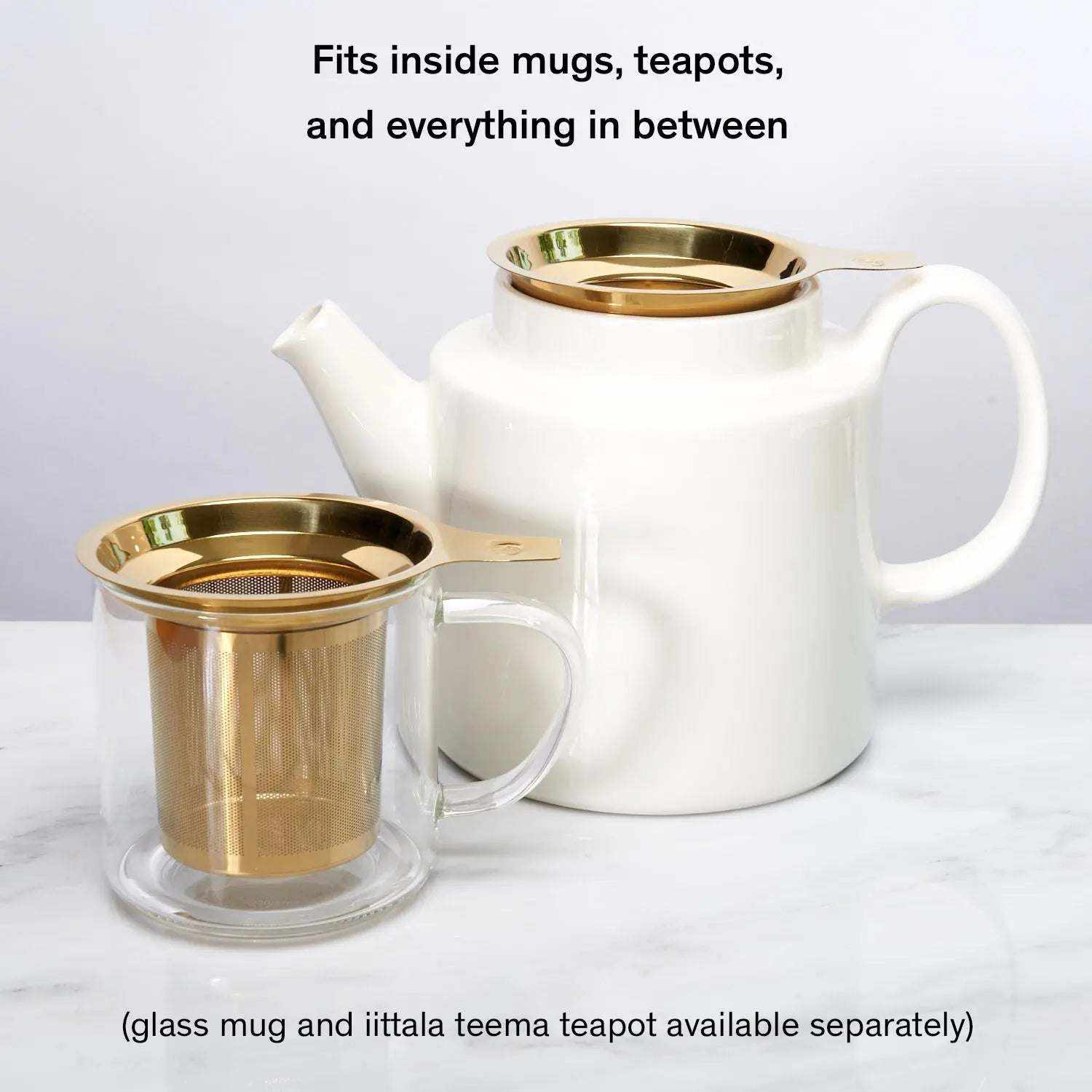 One Cup Infuser in gold-tone stainless steel with fine mesh basket, shown inside a glass mug and white teapot