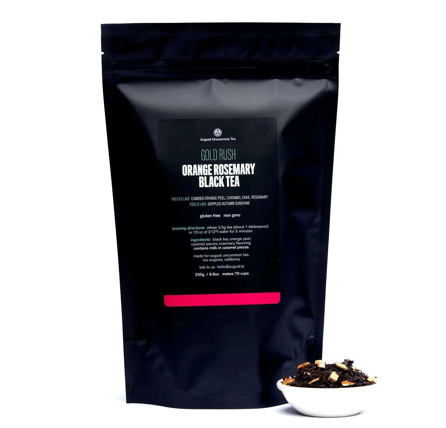 Orange Rosemary Caramel Black Tea in a black resealable pouch with a bowl of loose tea leaves and orange pieces