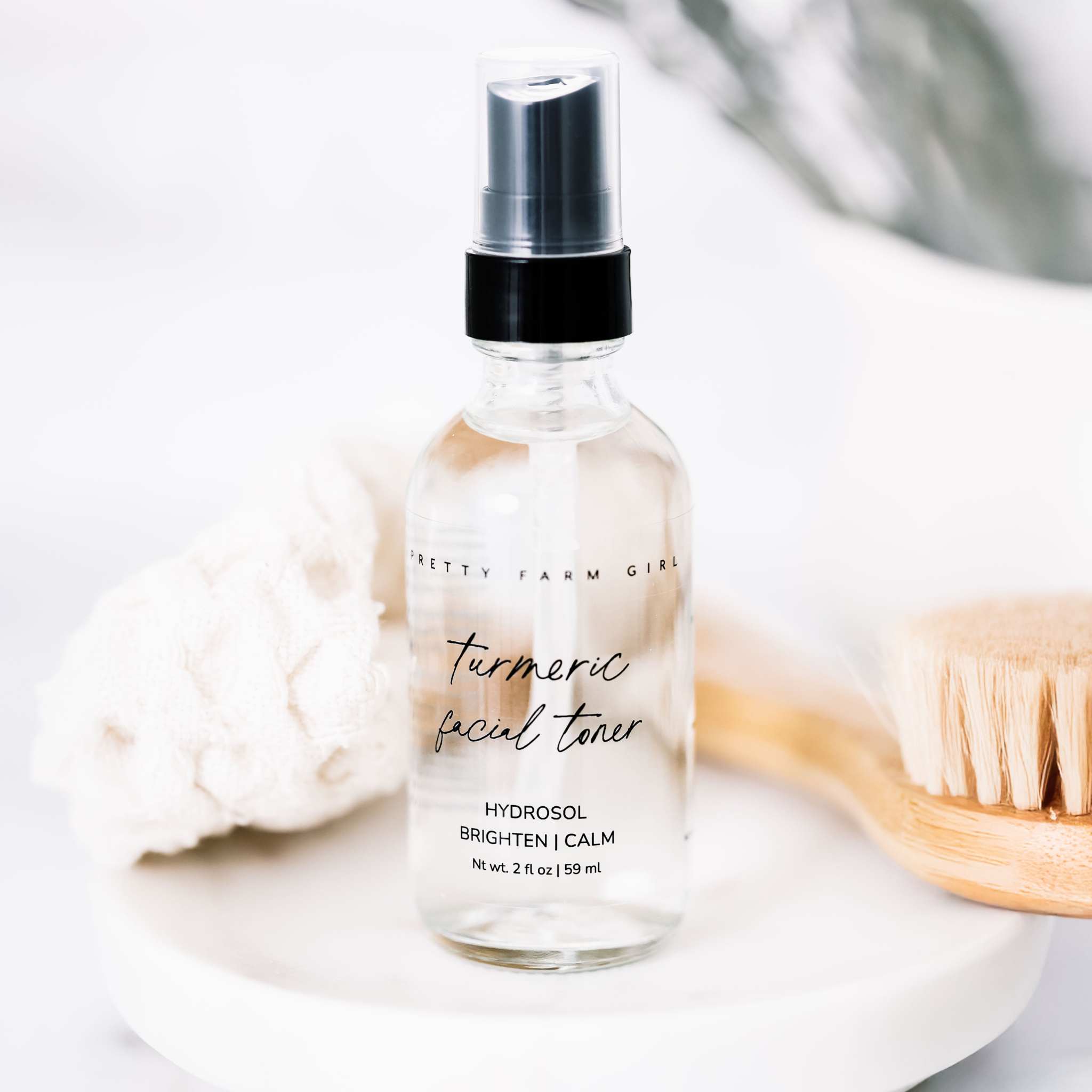 Organic Turmeric Facial Toner in a clear glass spray bottle with black pump and minimalist label