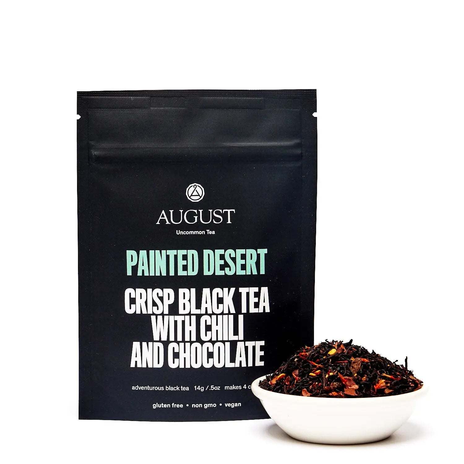 Painted Desert Tea black tea in a black pouch with chili and chocolate, shown beside loose tea in a white bowl