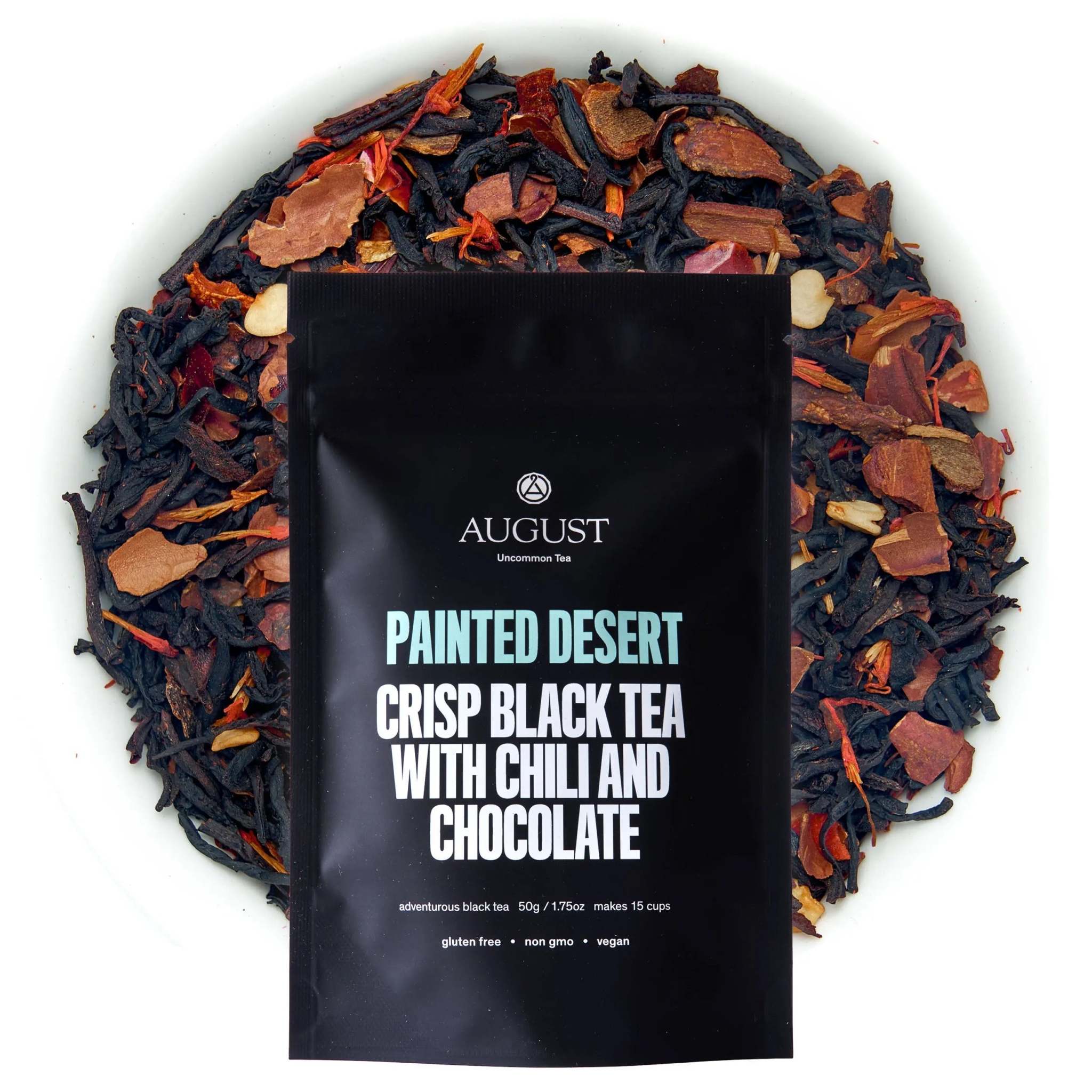 Painted Desert Tea black tea blend with chili, chocolate, cinnamon, and orange-red botanical pieces surrounding a branded pouch