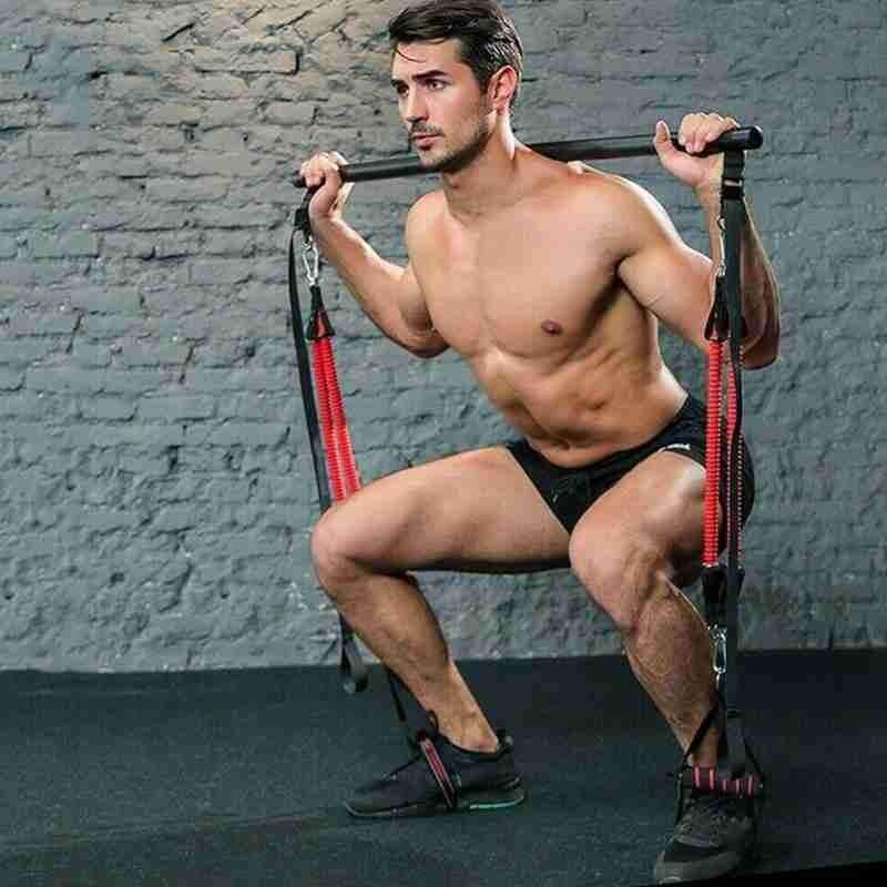 Pilates Bar Kit with black foam grip bar and red resistance bands used by a man doing a squat exercise