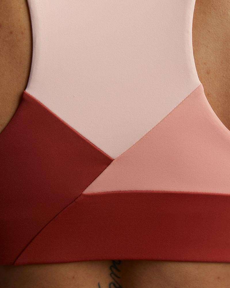 Pionxr Bra Top in blush pink and deep red color blocking, with smooth stretch fabric and clean diagonal seams