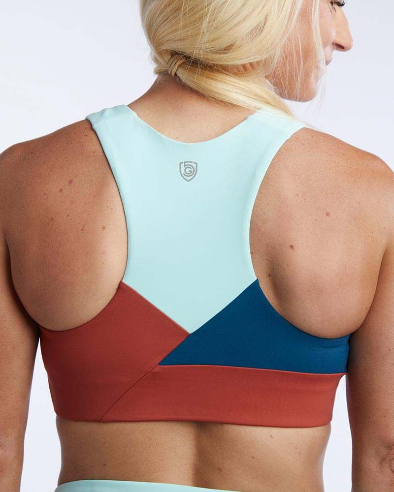 Pionxr Bra Top in coral red, pale aqua, and teal with a racerback cut and bold geometric color blocking