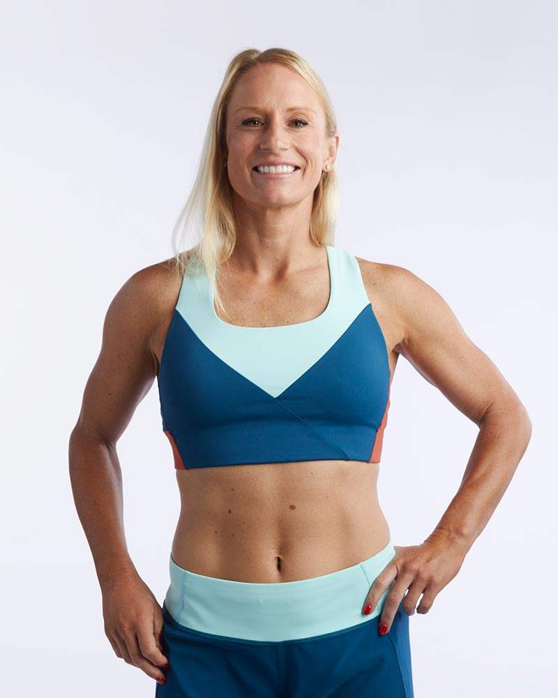 Pionxr Bra Top in navy blue with pale aqua color-blocked straps and V-shaped chest panel, clean seams and longline fit