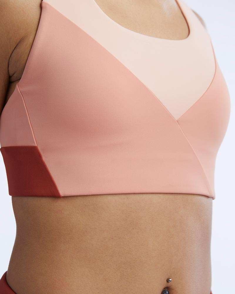 Pionxr Bra Top in peach and blush pink with smooth stretch fabric and bold geometric color-block panels