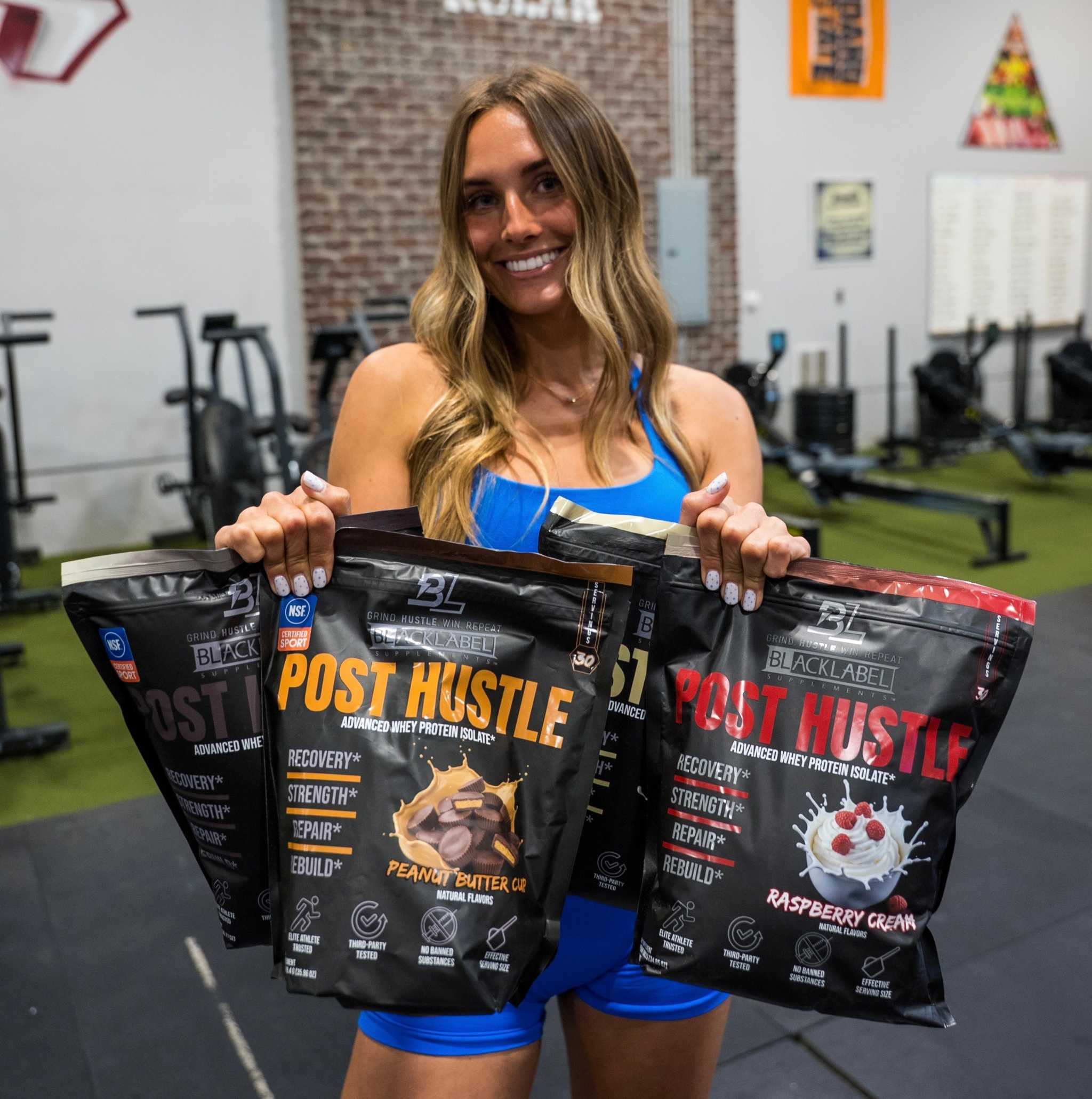 Whey protein isolate pouches for post-workout muscle recovery in black packaging, featuring peanut butter and raspberry cream flavors